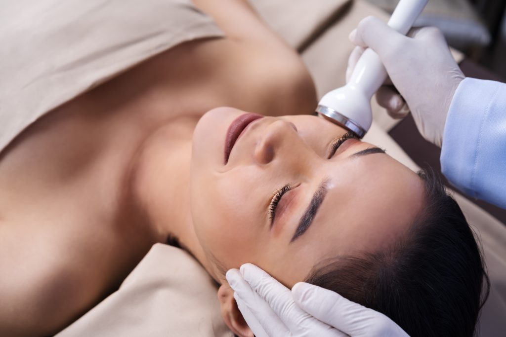 Young,Woman,Receiving,Ultrasound,Facial,Beauty,Treatment,Skin,Care